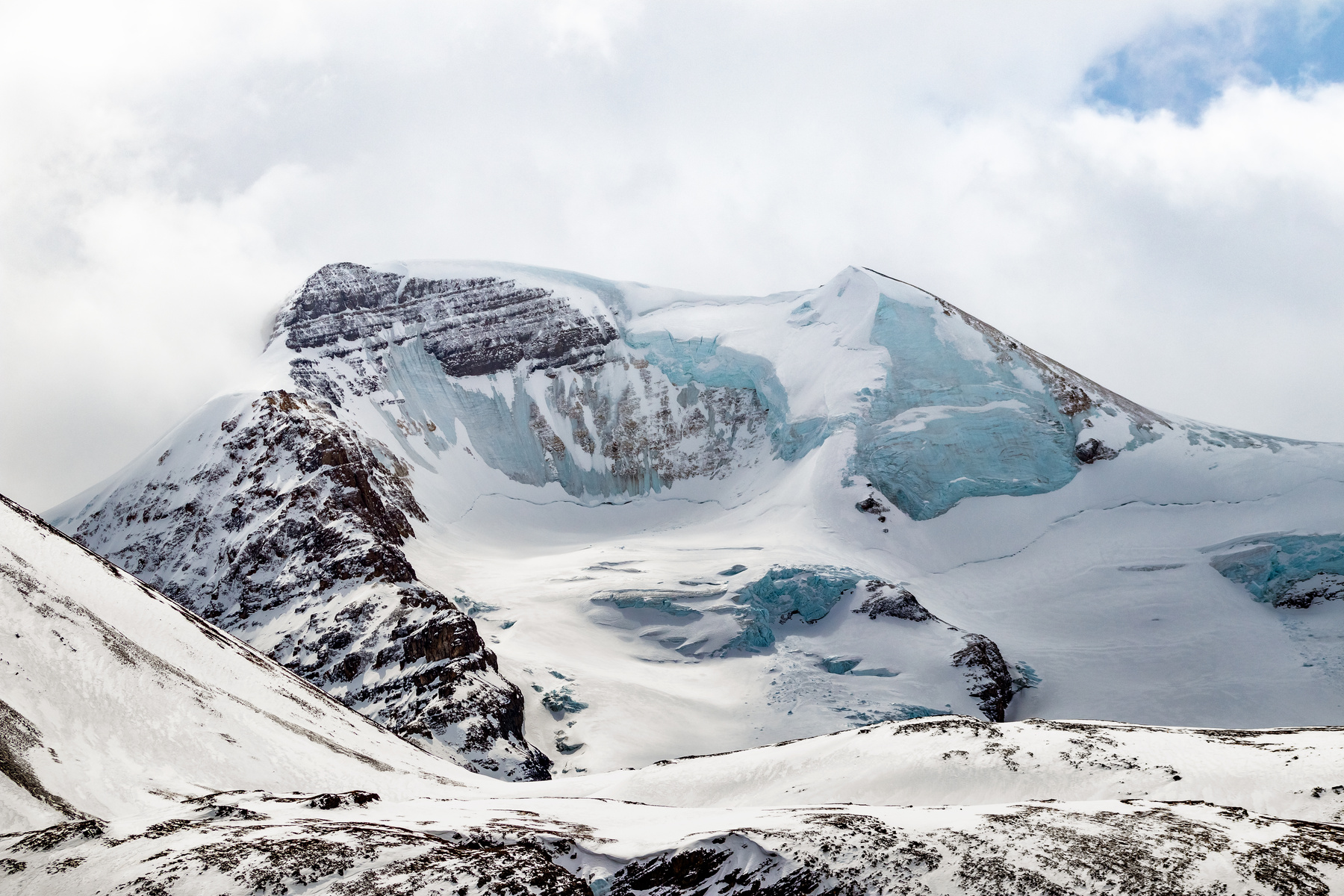 Snow Covered Mountain Under the Cloudy Sky